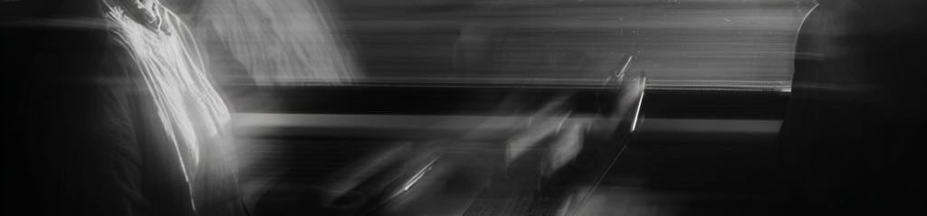 Barely discernible silhouette of two workers in a train